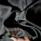 Beige asymmetrical blouse a high neck, made of translucent organza.
