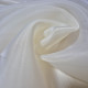 Beige asymmetrical blouse a high neck, made of translucent organza.