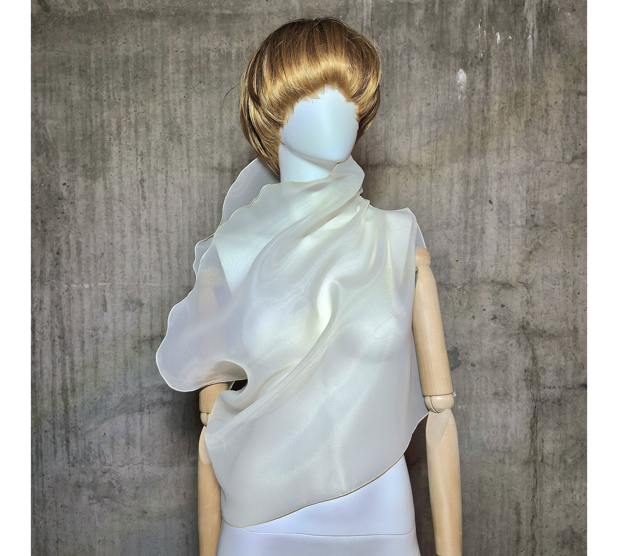 Beige asymmetrical blouse a high neck, made of translucent organza.
