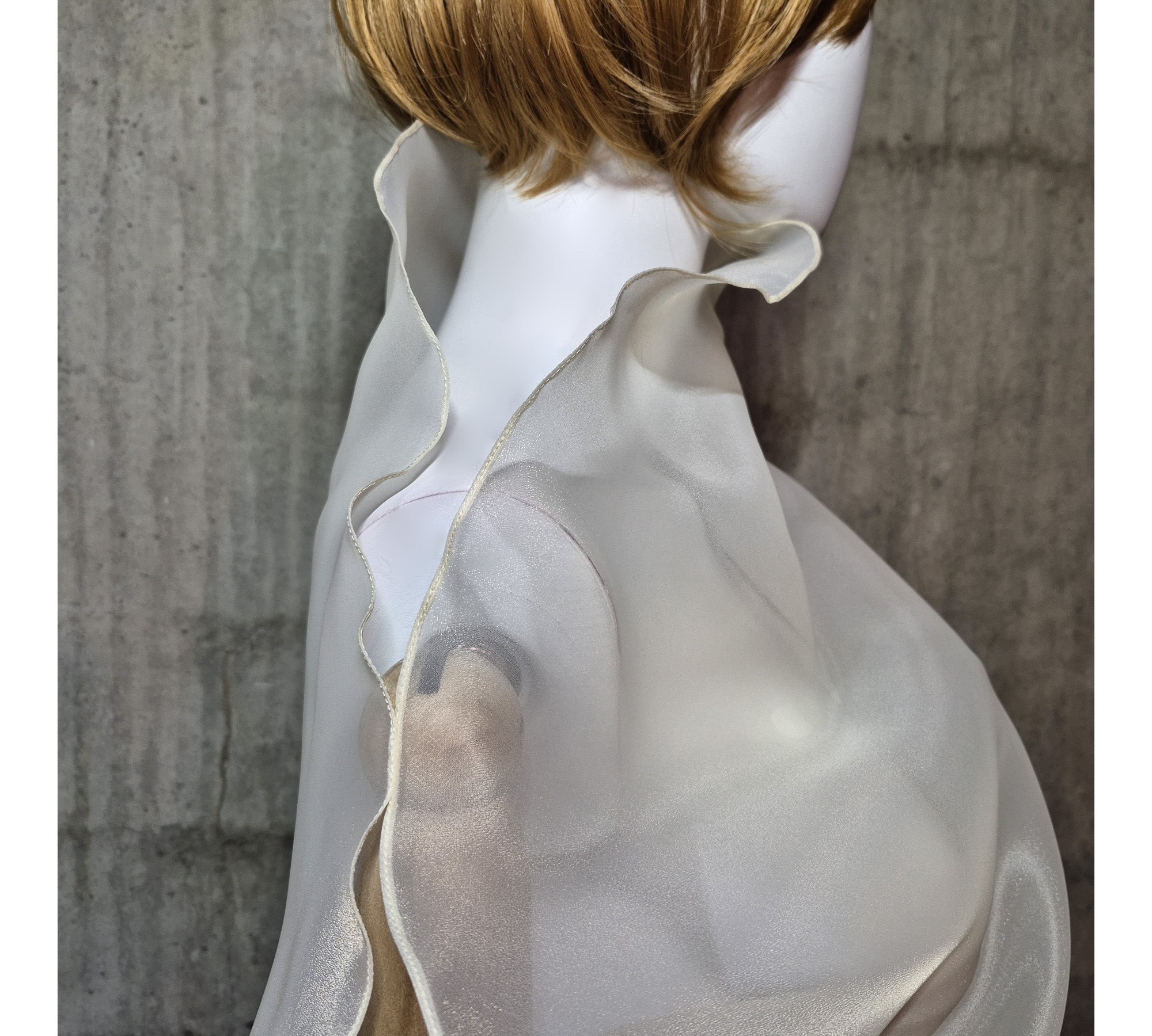 Beige asymmetrical blouse a high neck, made of translucent organza.