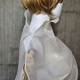 Beige asymmetrical blouse a high neck, made of translucent organza.