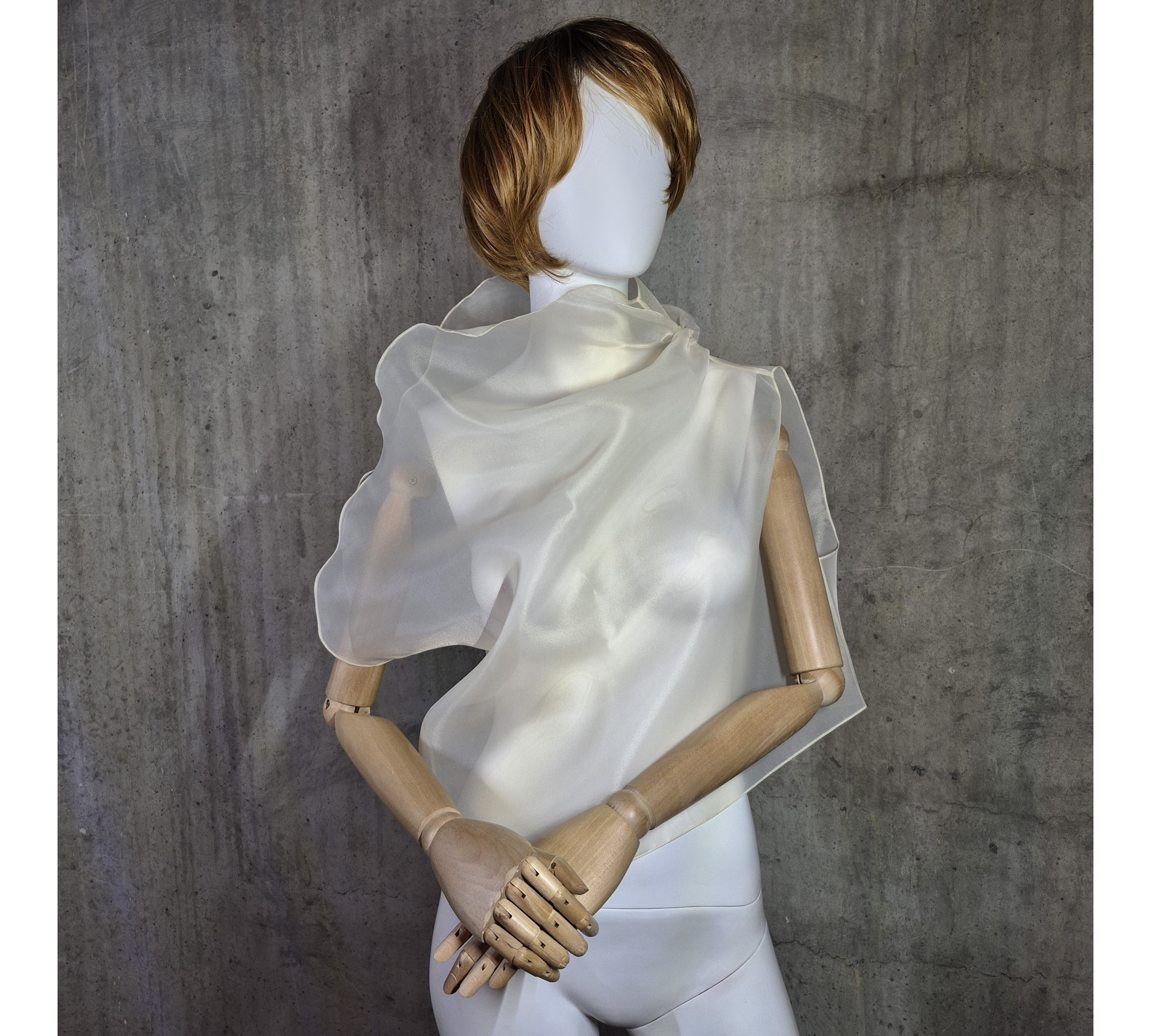 Beige asymmetrical blouse a high neck, made of translucent organza.