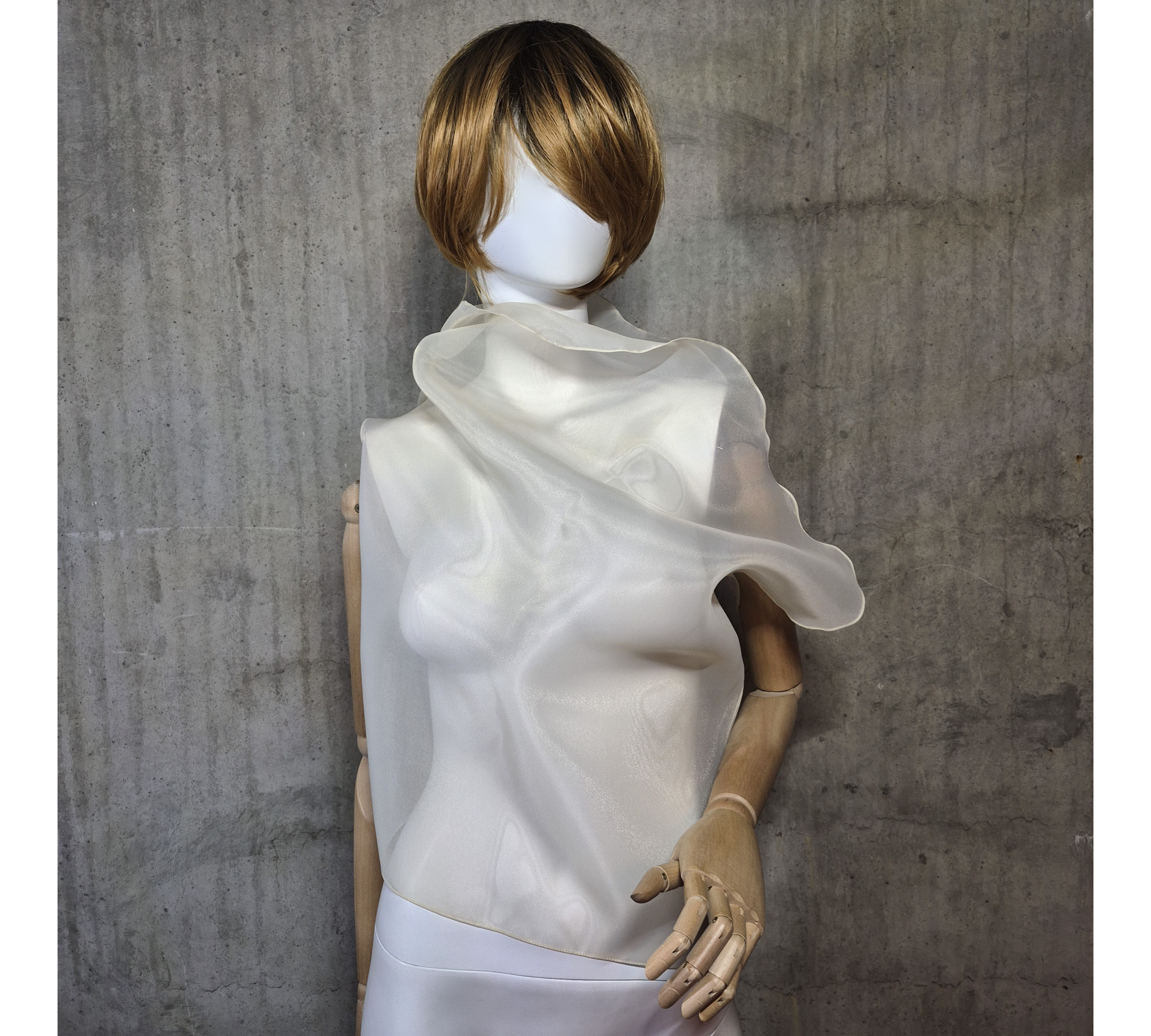 Beige asymmetrical blouse a high neck, made of translucent organza.