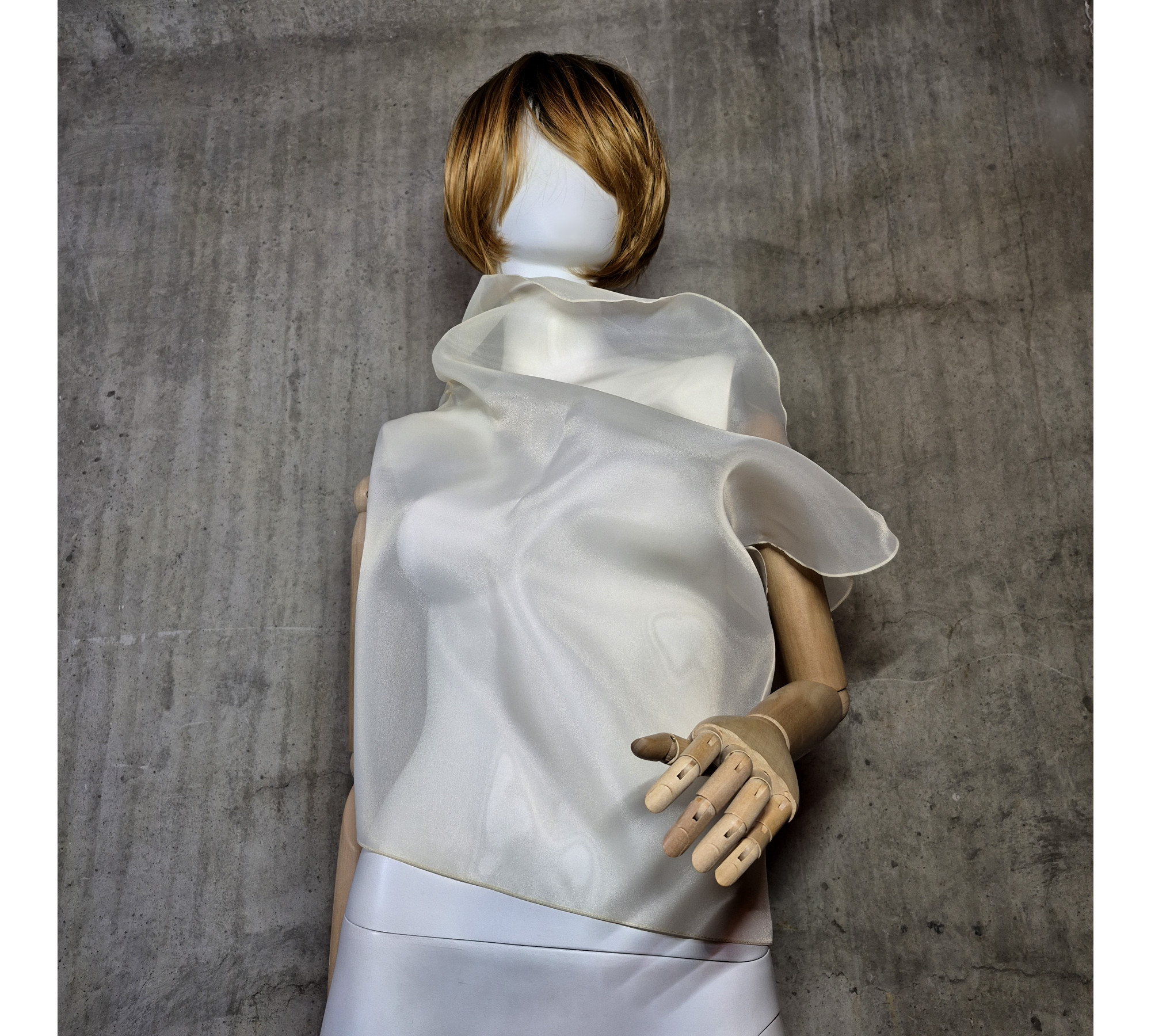 Beige asymmetrical blouse a high neck, made of translucent organza.