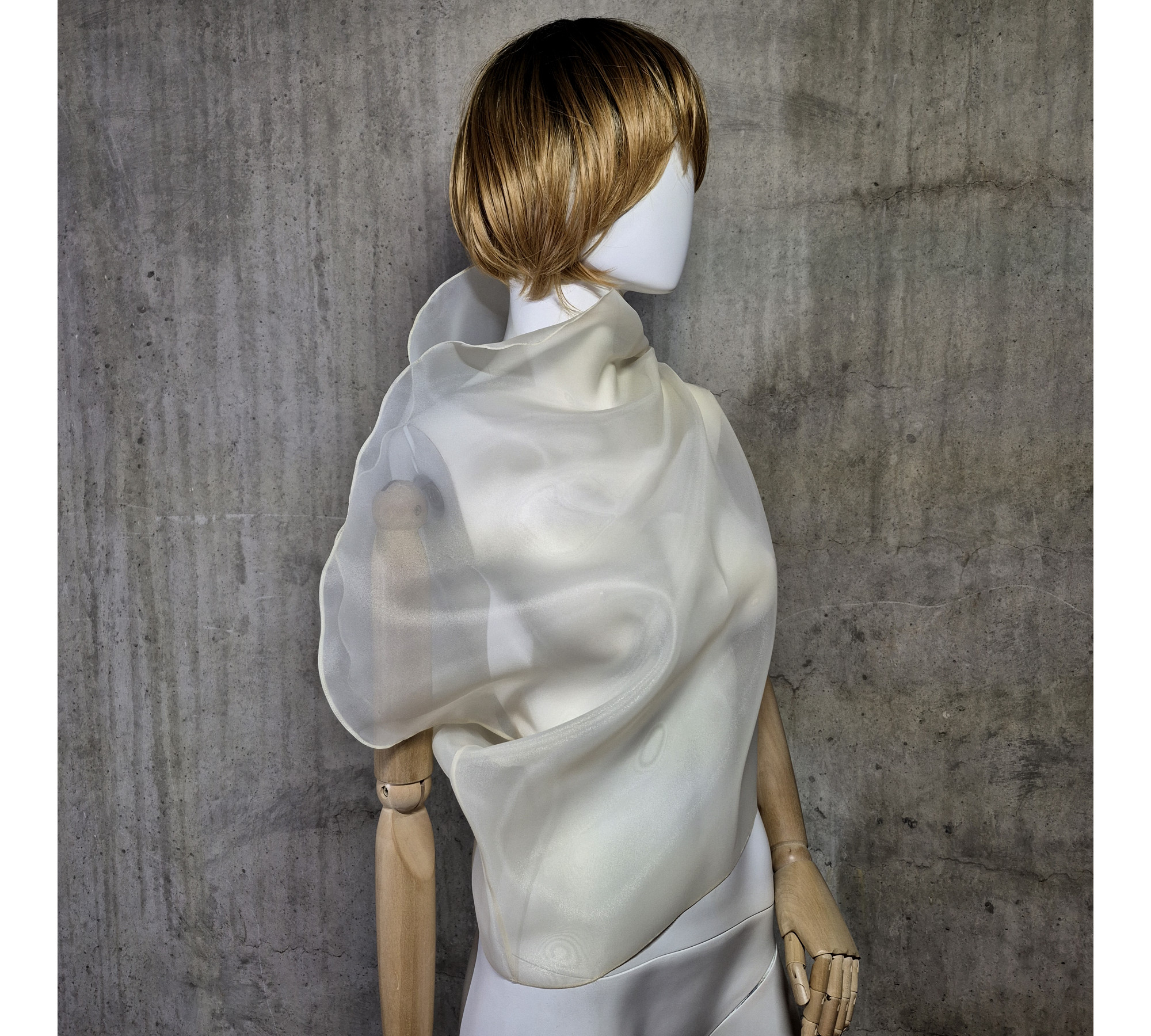 Beige asymmetrical blouse a high neck, made of translucent organza.