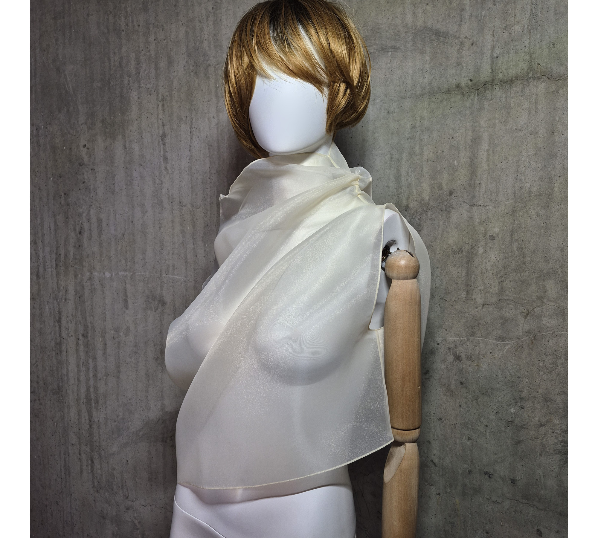 Beige asymmetrical blouse a high neck, made of translucent organza.