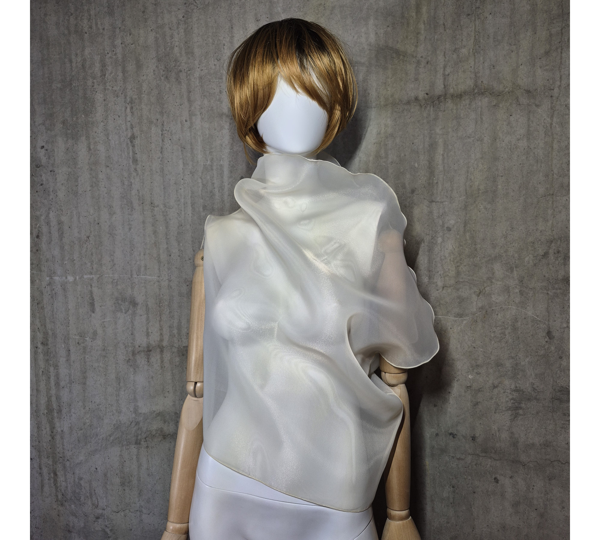 Beige asymmetrical blouse a high neck, made of translucent organza.