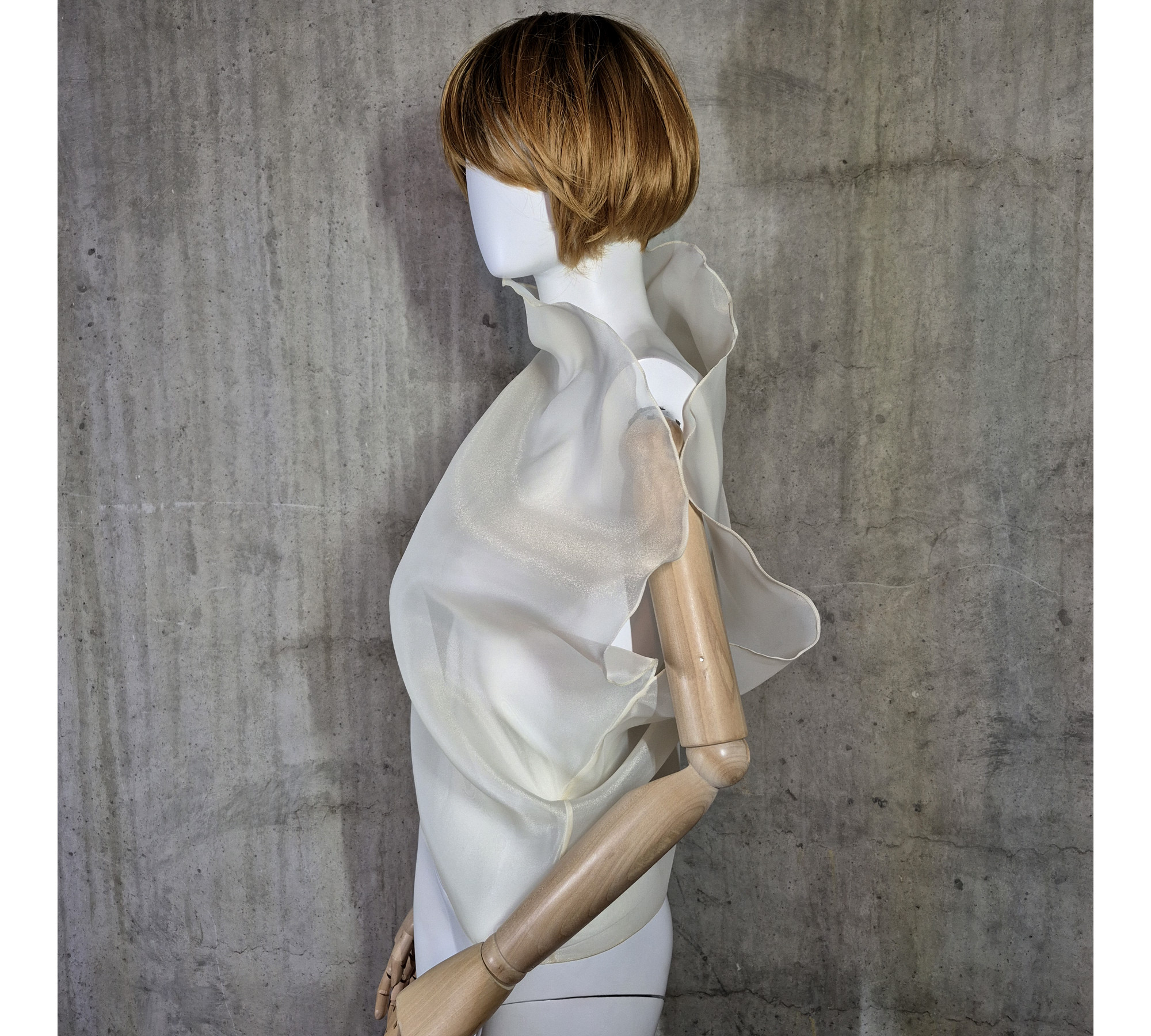 Beige asymmetrical blouse a high neck, made of translucent organza.