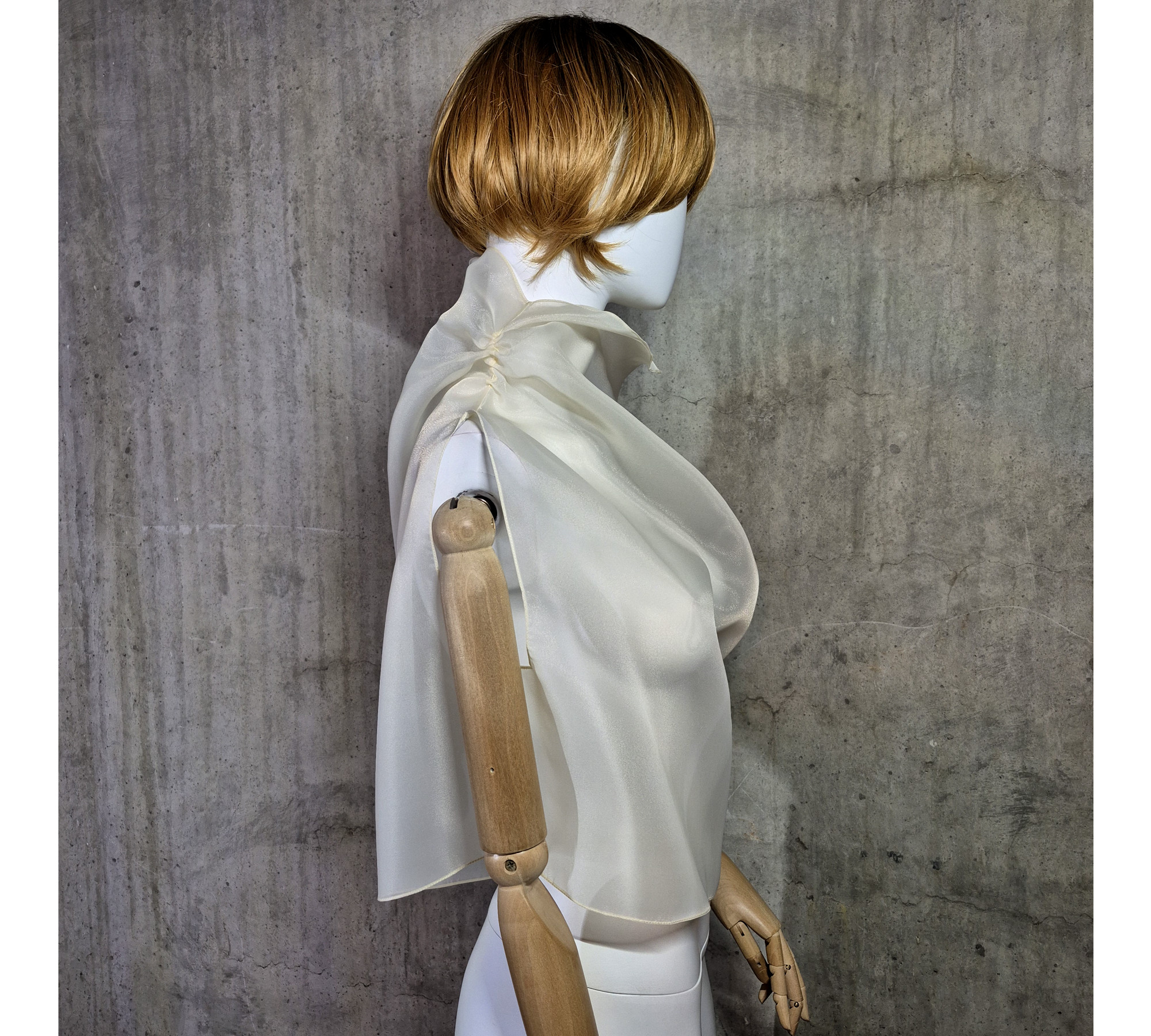 Beige asymmetrical blouse a high neck, made of translucent organza.
