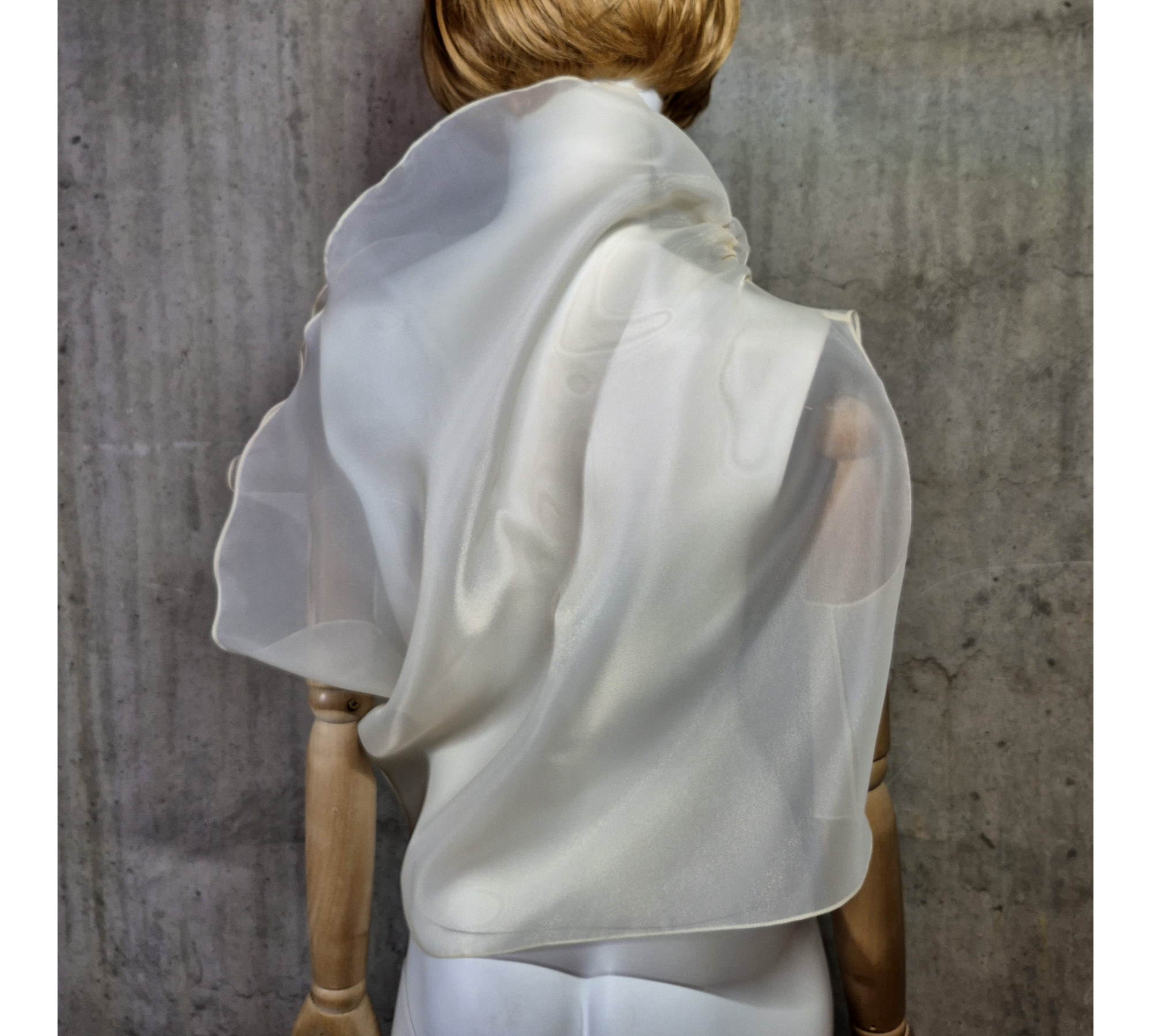 Beige asymmetrical blouse a high neck, made of translucent organza.