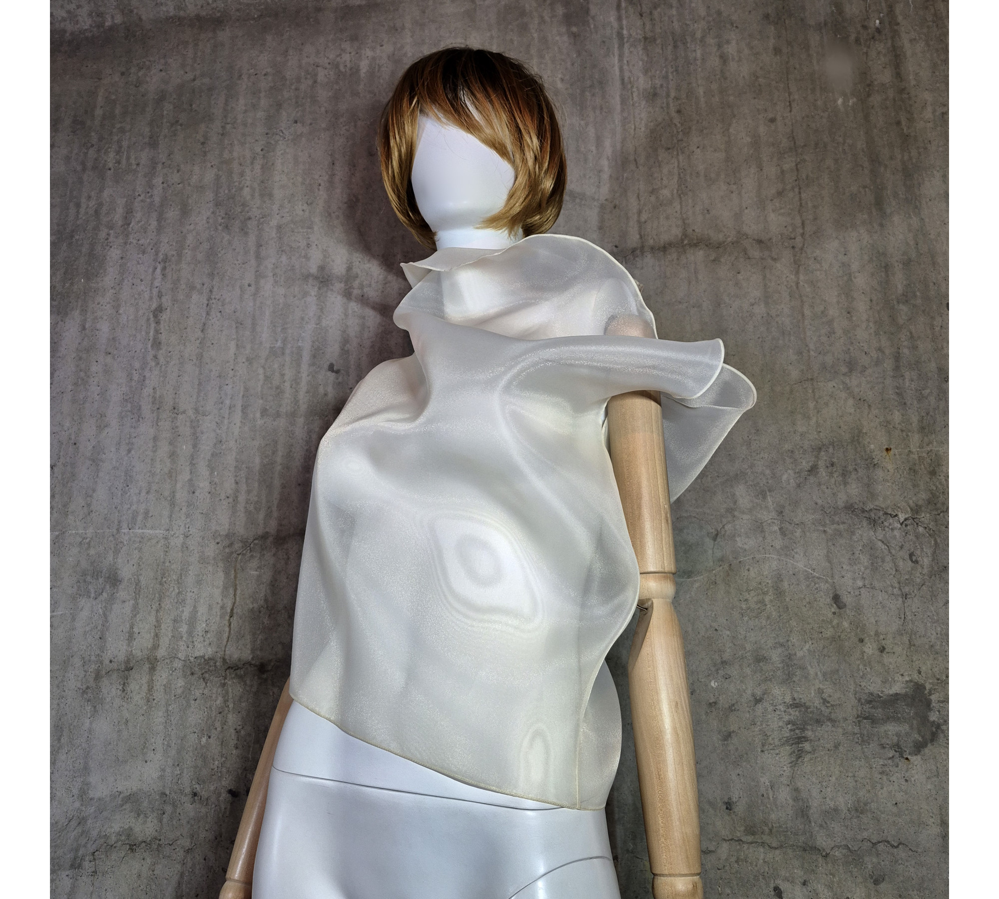 Beige asymmetrical blouse a high neck, made of translucent organza.