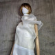 Beige asymmetrical blouse a high neck, made of translucent organza.