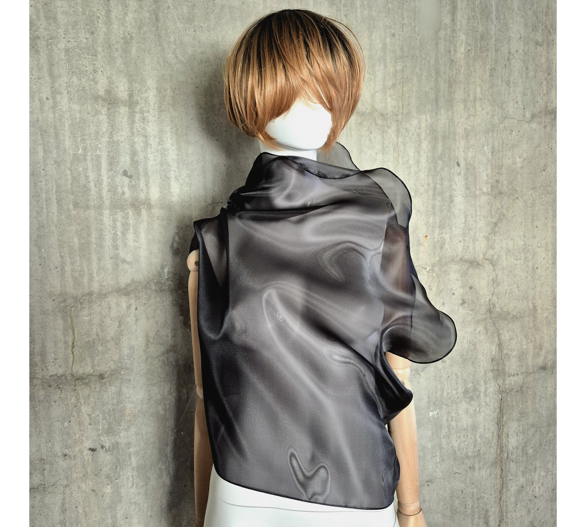 Black asymmetrical blouse a high neck, made of translucent organza.