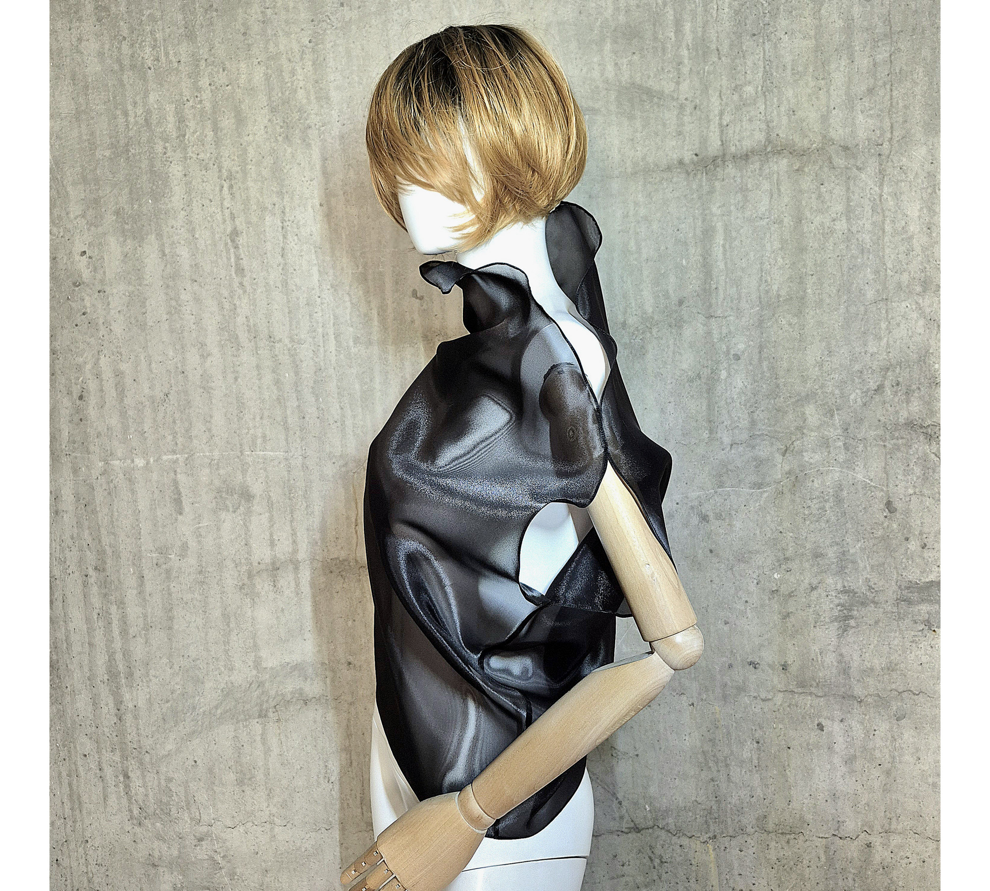 Black asymmetrical blouse a high neck, made of translucent organza.