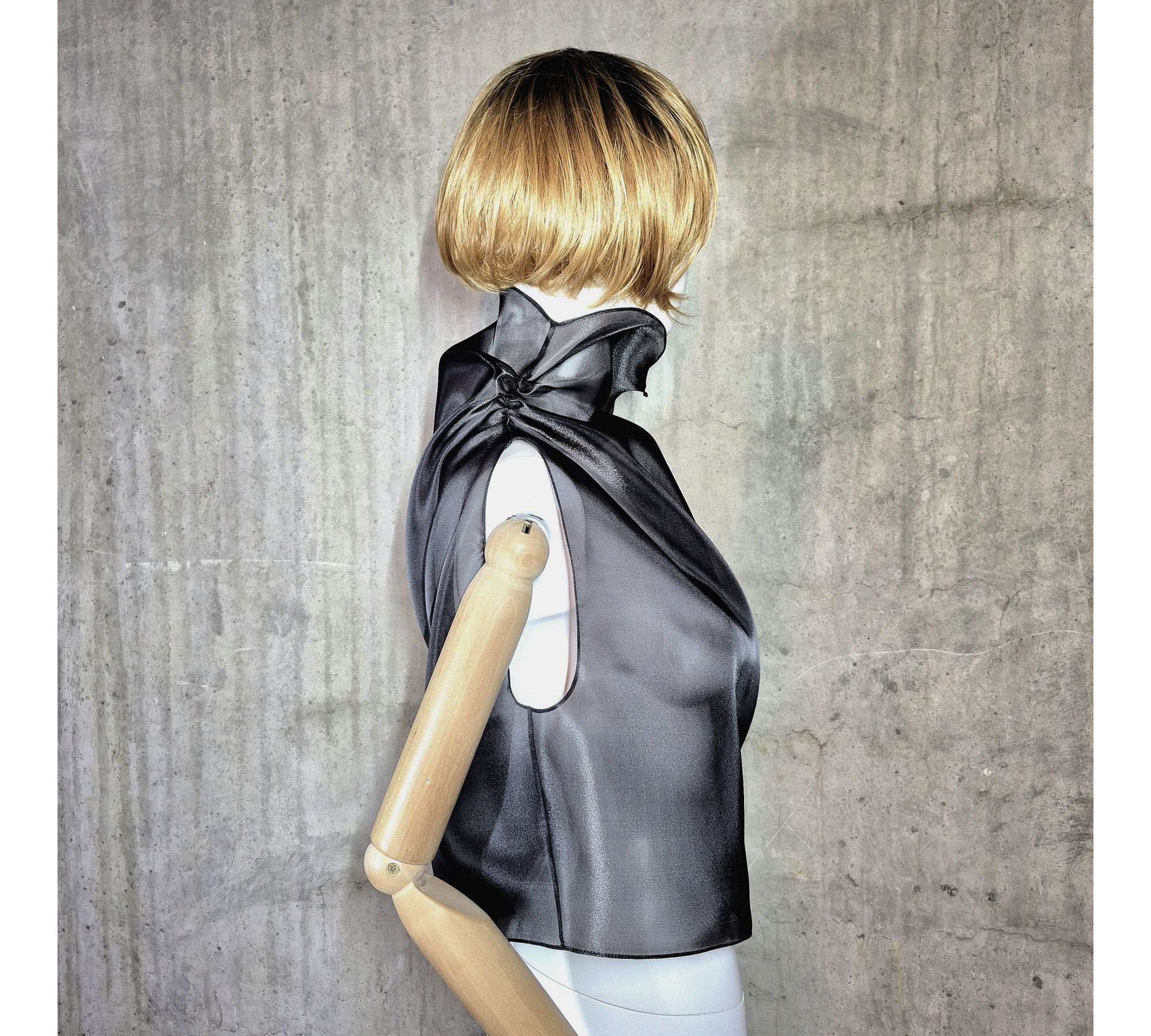 Black asymmetrical blouse a high neck, made of translucent organza.