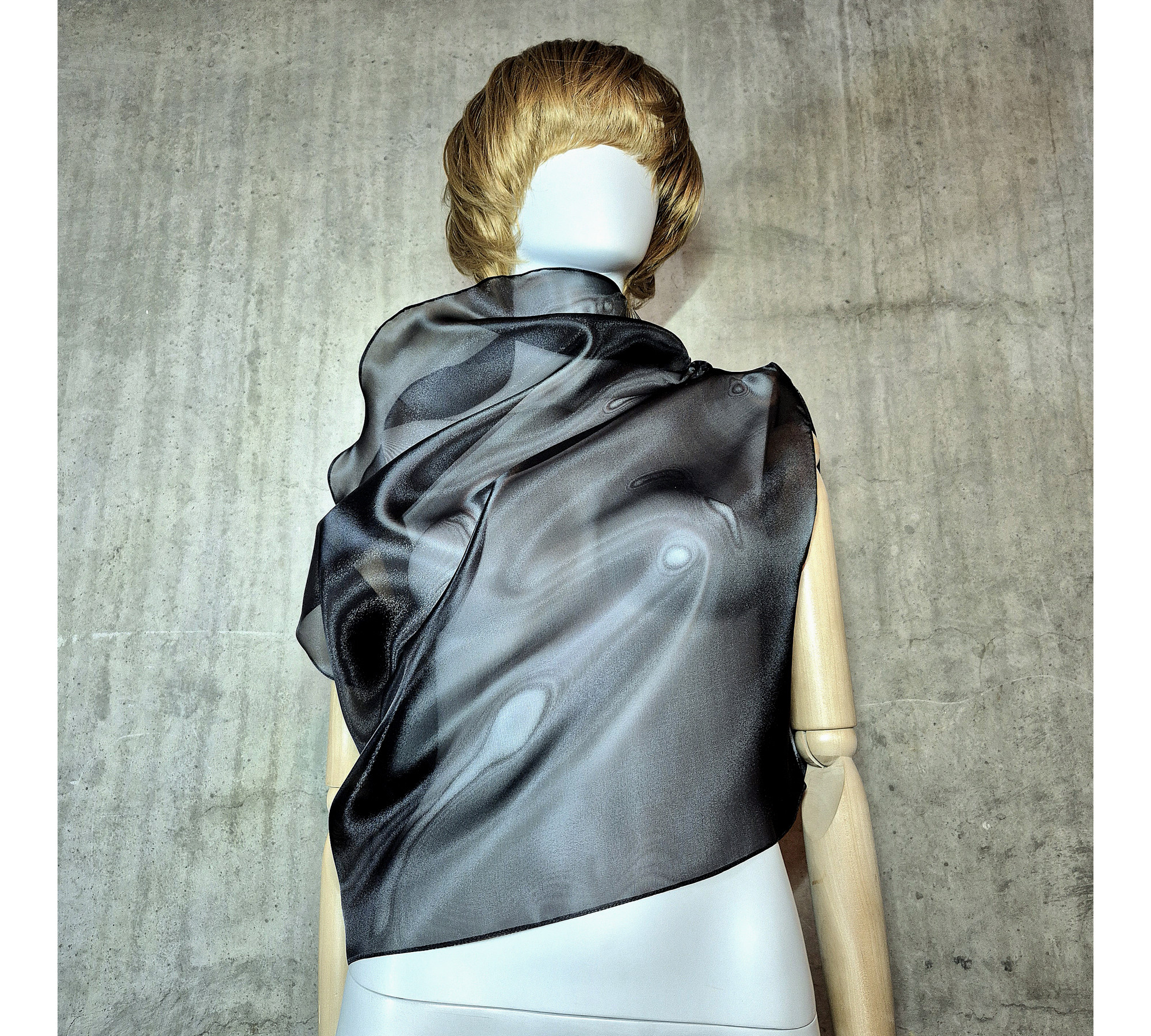 Black asymmetrical blouse a high neck, made of translucent organza.