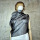 Black asymmetrical blouse a high neck, made of translucent organza.