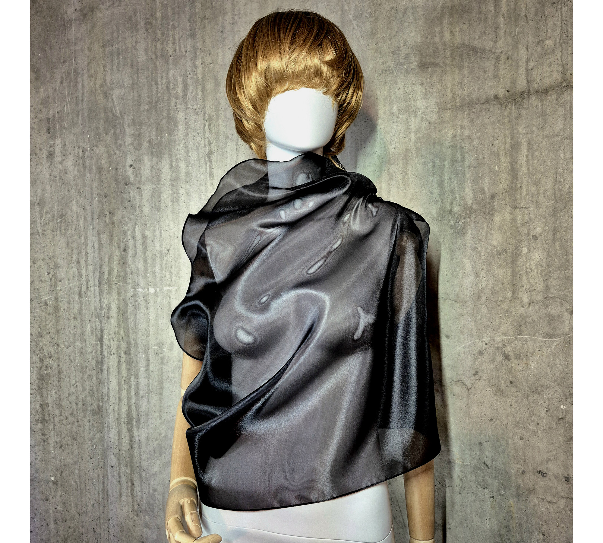 Black asymmetrical blouse a high neck, made of translucent organza.