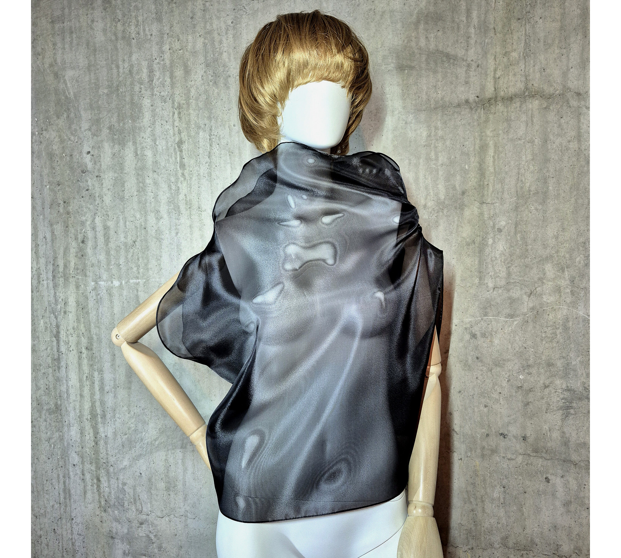 Black asymmetrical blouse a high neck, made of translucent organza.