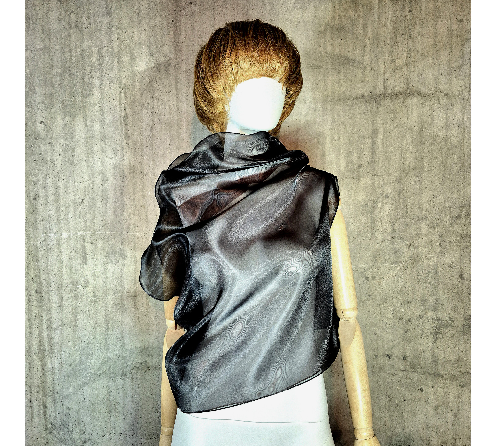 Black asymmetrical blouse a high neck, made of translucent organza.