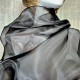 Black asymmetrical blouse a high neck, made of translucent organza.