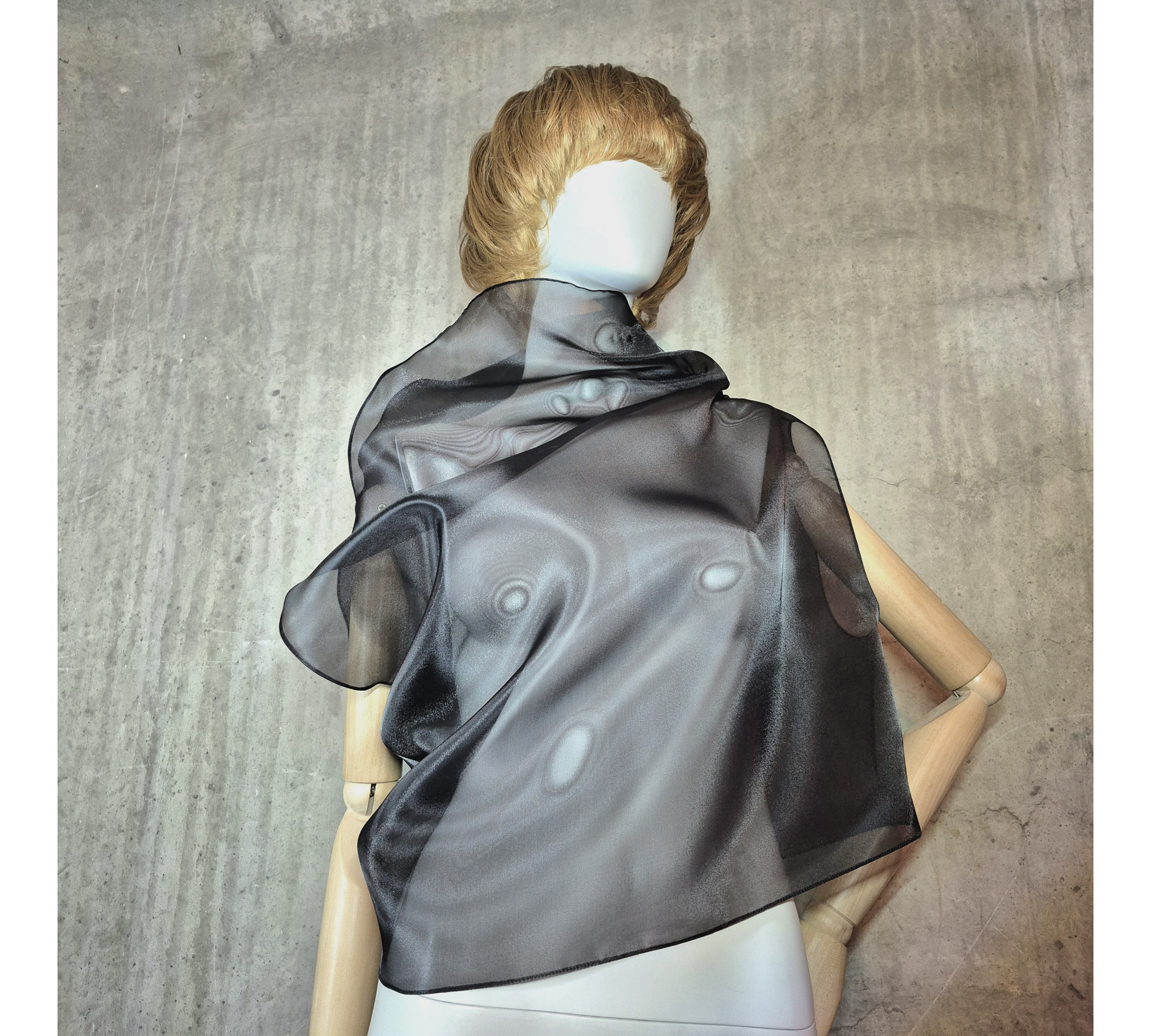 Black asymmetrical blouse a high neck, made of translucent organza.