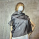 Black asymmetrical blouse a high neck, made of translucent organza.