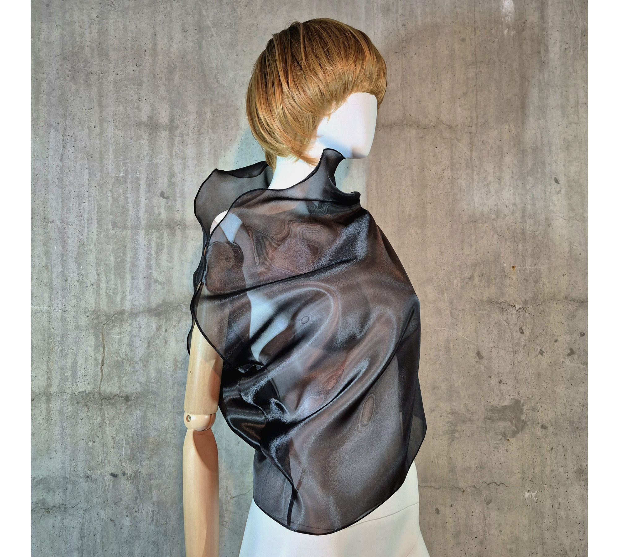 Black asymmetrical blouse a high neck, made of translucent organza.