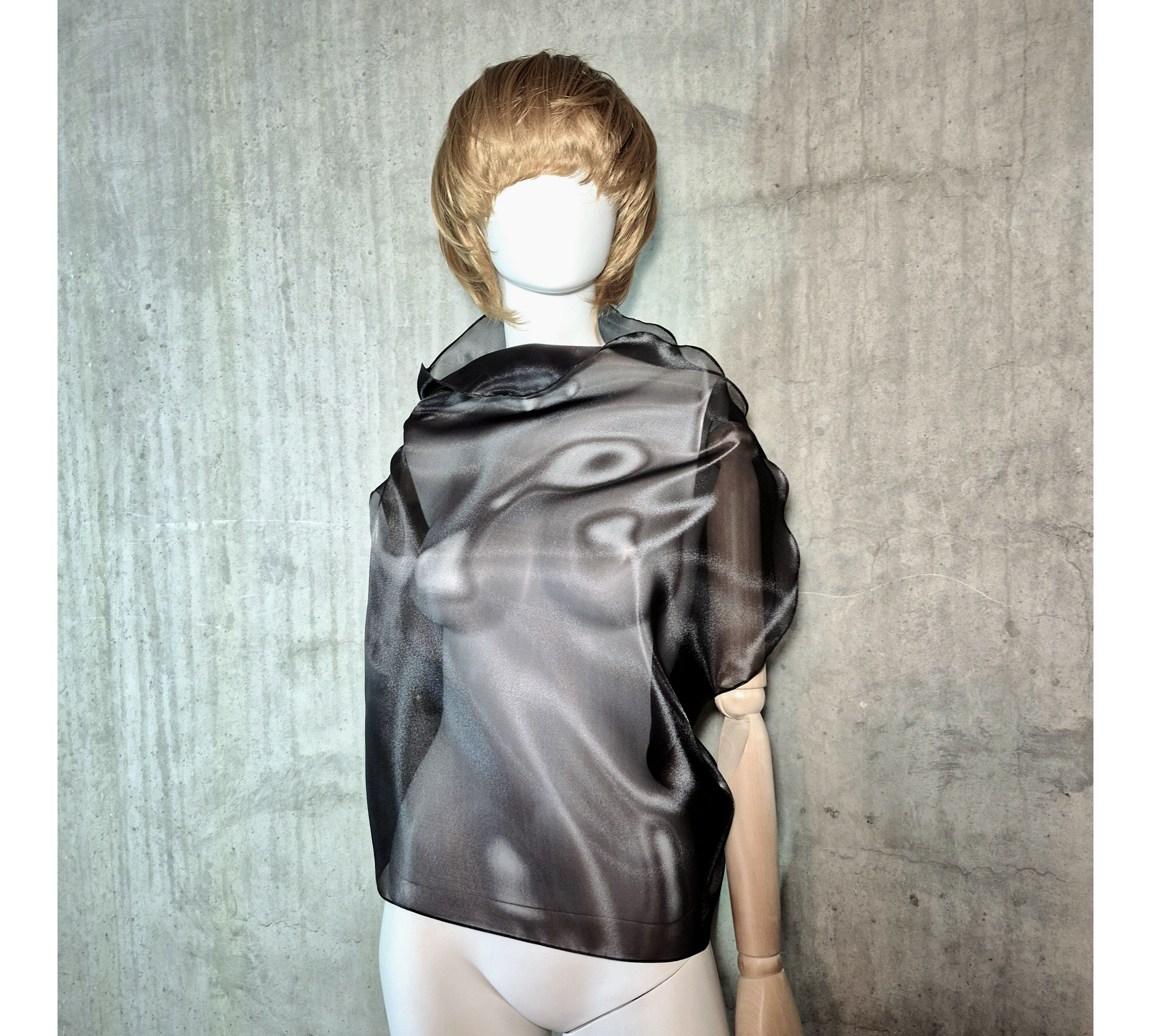 Black asymmetrical blouse a high neck, made of translucent organza.