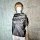 Black asymmetrical blouse a high neck, made of translucent organza.