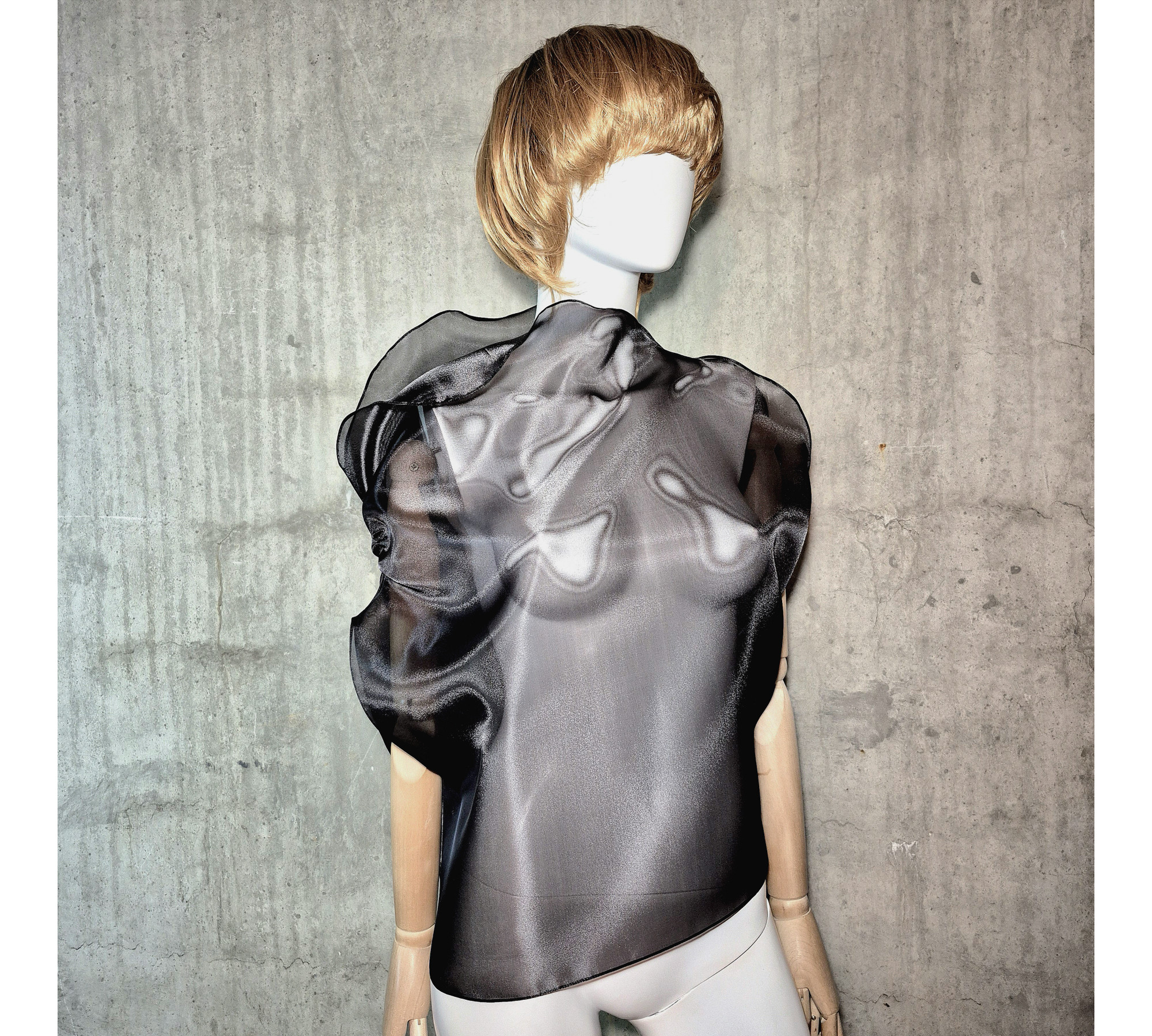 Black asymmetrical blouse a high neck, made of translucent organza.