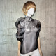 Black asymmetrical blouse a high neck, made of translucent organza.