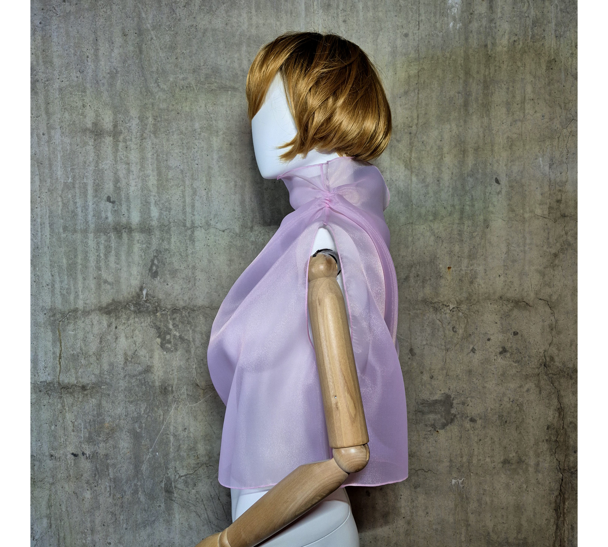 Pink asymmetrical blouse a high neck, made of translucent organza.