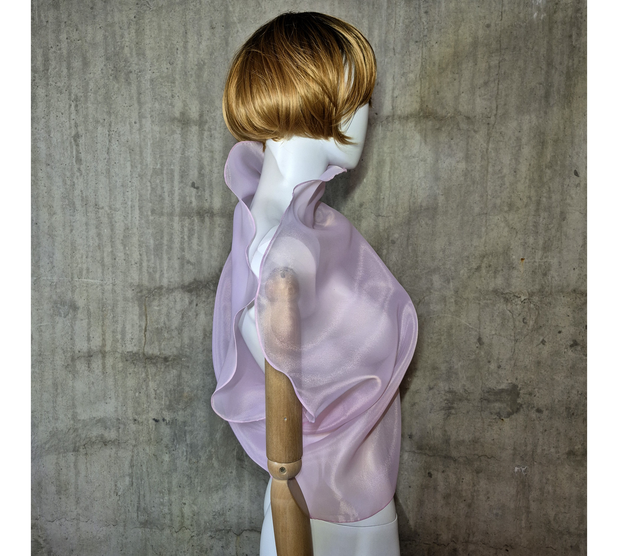 Pink asymmetrical blouse a high neck, made of translucent organza.