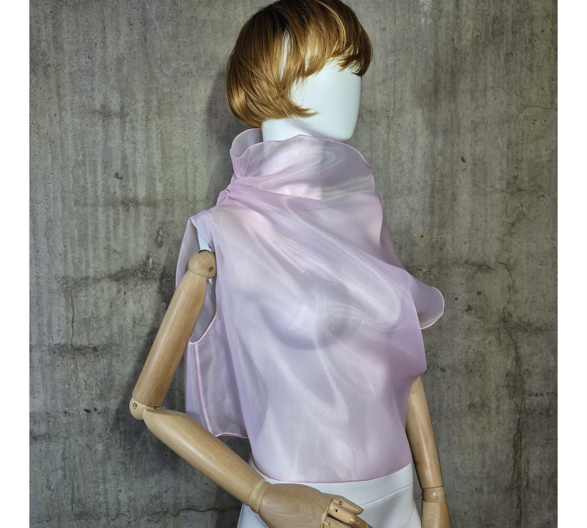 Pink asymmetrical blouse a high neck, made of translucent organza.