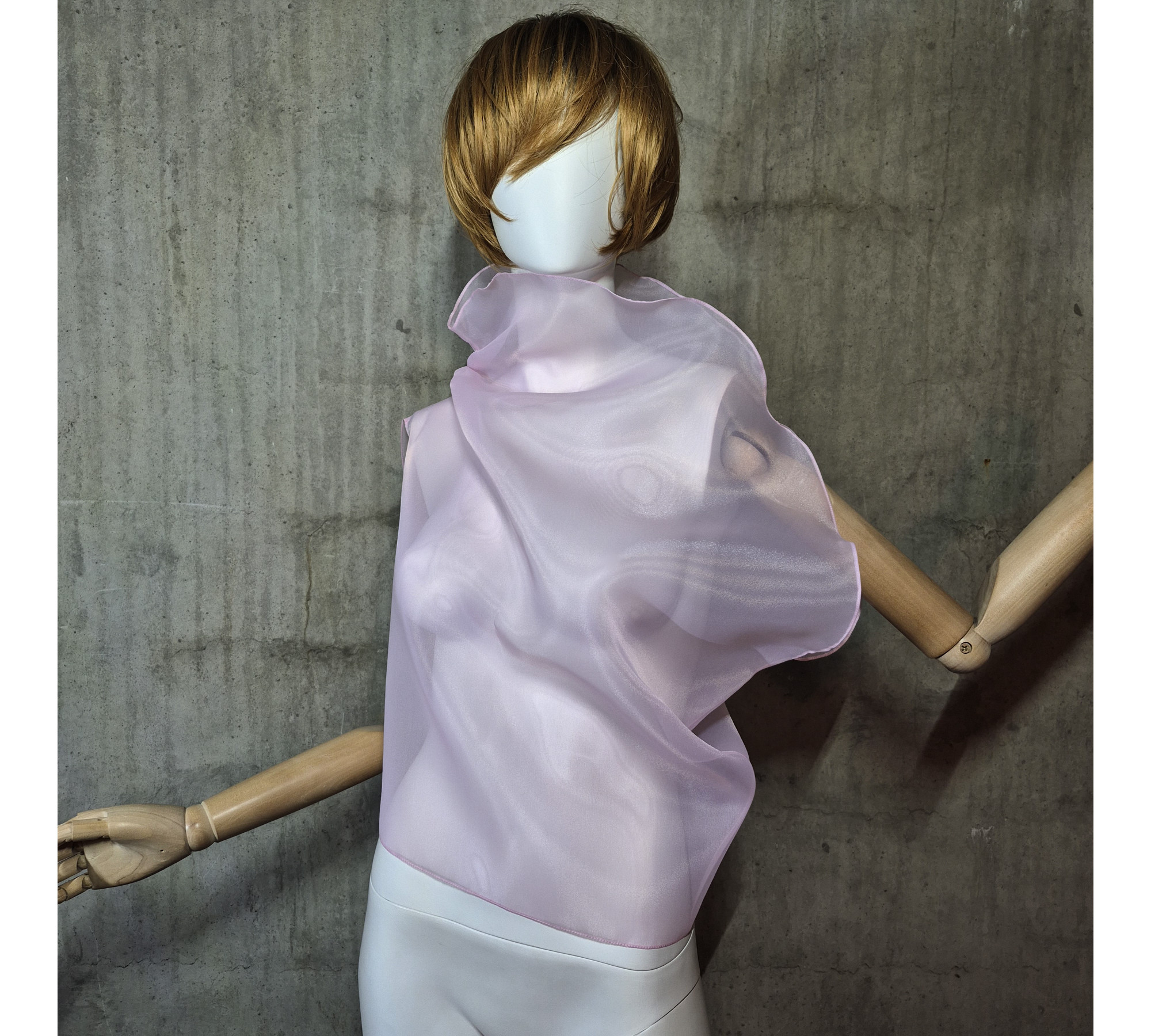 Pink asymmetrical blouse a high neck, made of translucent organza.